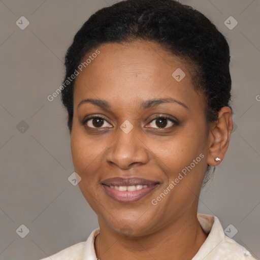 Joyful black adult female with short  brown hair and brown eyes