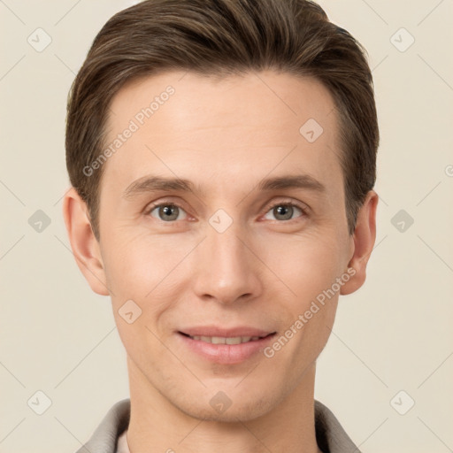 Joyful white young-adult male with short  brown hair and grey eyes