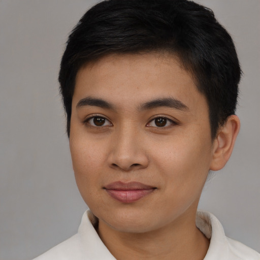 Joyful asian young-adult male with short  brown hair and brown eyes