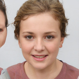 Joyful white child female with short  brown hair and brown eyes