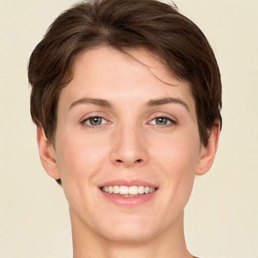 Joyful white young-adult female with short  brown hair and green eyes