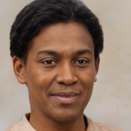 Joyful latino young-adult male with short  brown hair and brown eyes