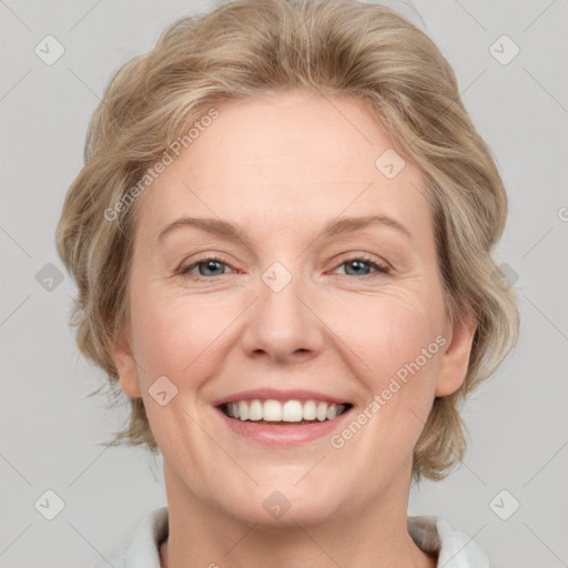 Joyful white adult female with medium  brown hair and blue eyes