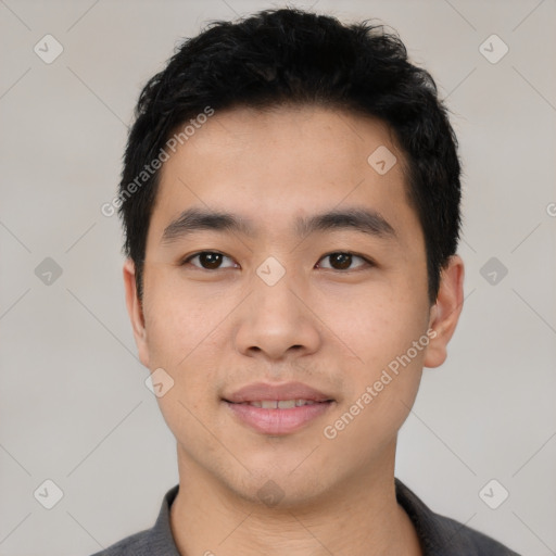 Joyful asian young-adult male with short  black hair and brown eyes