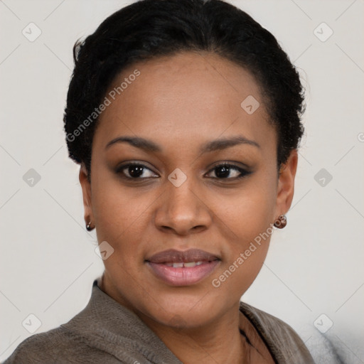 Joyful black young-adult female with short  black hair and brown eyes