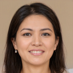 Joyful white young-adult female with long  brown hair and brown eyes