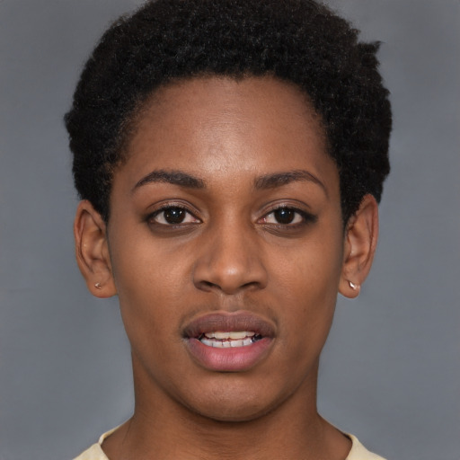 Joyful black young-adult female with short  brown hair and brown eyes
