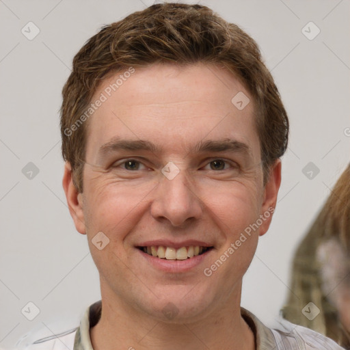 Joyful white adult male with short  brown hair and grey eyes