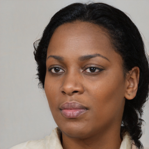 Joyful black young-adult female with medium  black hair and brown eyes
