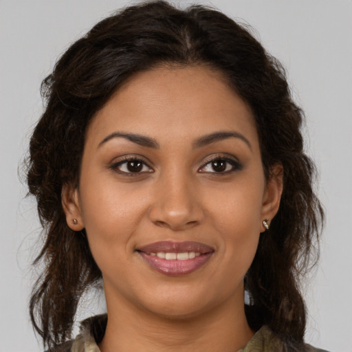 Joyful latino young-adult female with long  brown hair and brown eyes