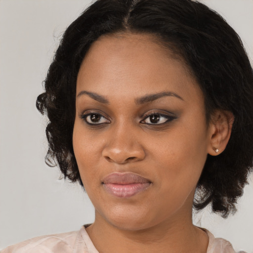 Joyful black young-adult female with medium  black hair and brown eyes
