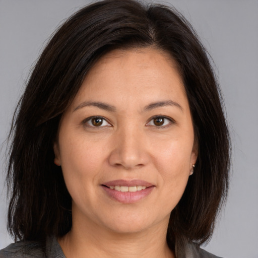 Joyful white adult female with medium  brown hair and brown eyes