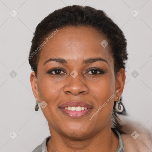 Joyful black adult female with short  brown hair and brown eyes