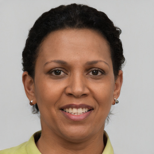 Joyful latino adult female with short  brown hair and brown eyes