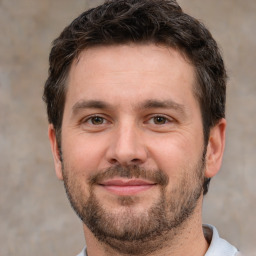 Joyful white adult male with short  brown hair and brown eyes