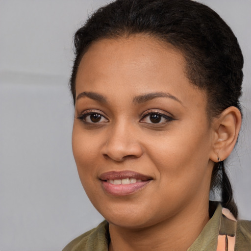 Joyful black young-adult female with long  brown hair and brown eyes