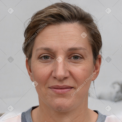 Joyful white adult female with short  brown hair and grey eyes