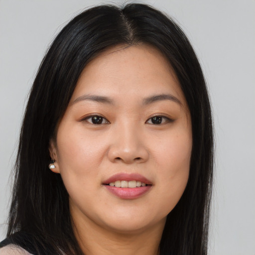 Joyful asian young-adult female with long  brown hair and brown eyes