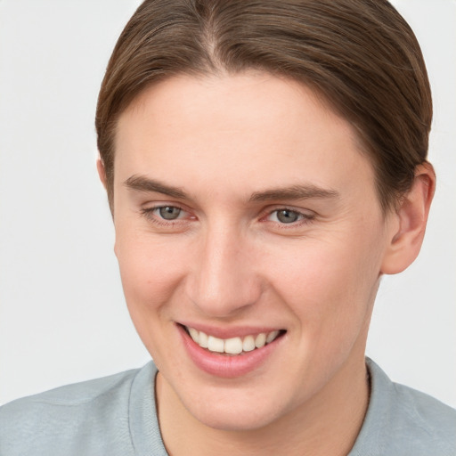 Joyful white young-adult female with short  brown hair and grey eyes