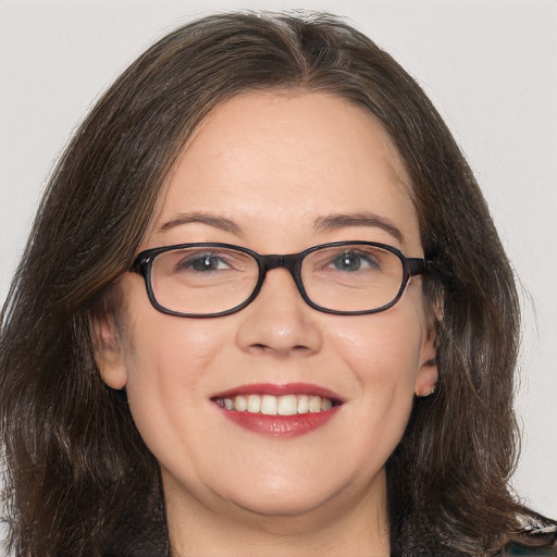 Joyful white adult female with long  brown hair and brown eyes