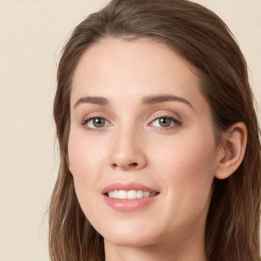 Joyful white young-adult female with long  brown hair and green eyes