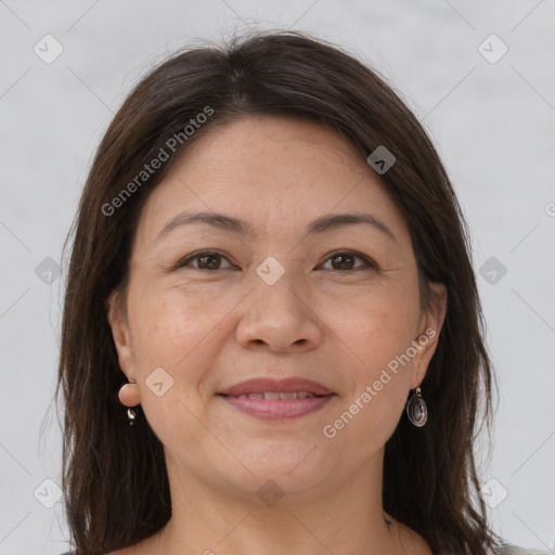 Joyful white adult female with long  brown hair and brown eyes