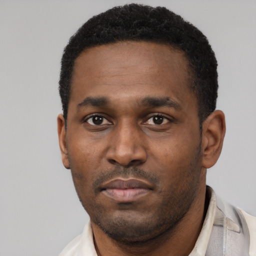 Neutral black young-adult male with short  black hair and brown eyes