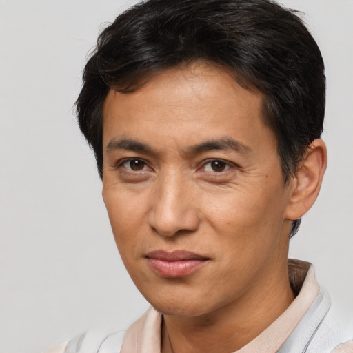 Joyful asian adult male with short  brown hair and brown eyes