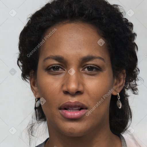 Joyful black young-adult female with long  brown hair and brown eyes