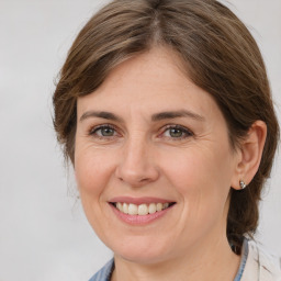 Joyful white adult female with medium  brown hair and brown eyes