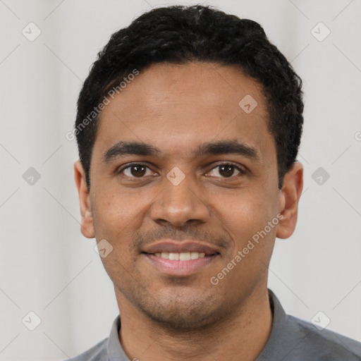 Joyful black young-adult male with short  black hair and brown eyes