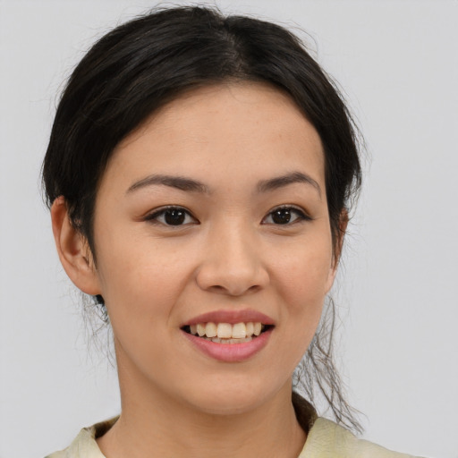 Joyful asian young-adult female with medium  brown hair and brown eyes