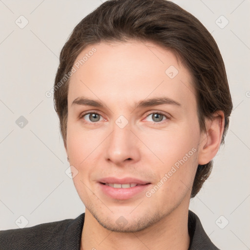 Joyful white young-adult male with short  brown hair and grey eyes