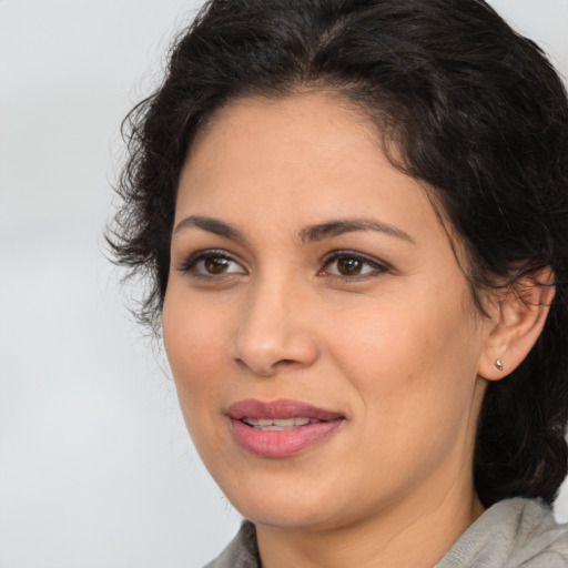 Joyful latino young-adult female with medium  brown hair and brown eyes