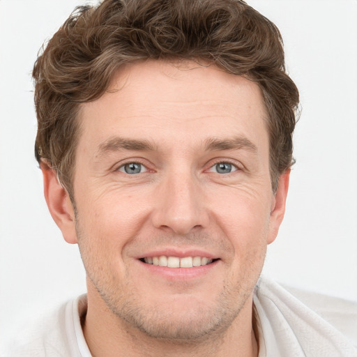 Joyful white adult male with short  brown hair and grey eyes