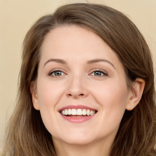 Joyful white young-adult female with long  brown hair and grey eyes