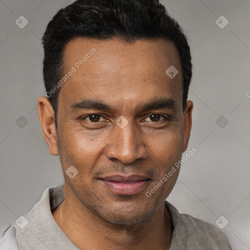 Joyful black adult male with short  black hair and brown eyes