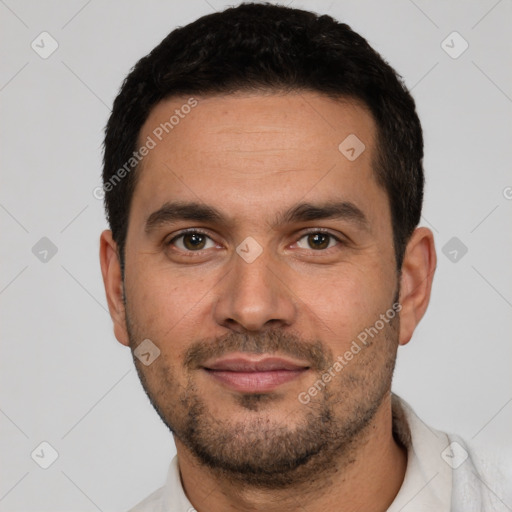 Joyful white young-adult male with short  black hair and brown eyes