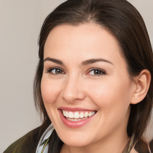 Joyful white young-adult female with medium  brown hair and brown eyes