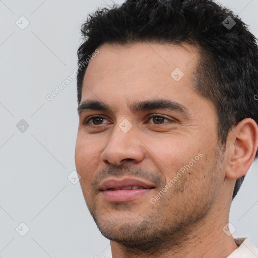 Joyful white young-adult male with short  black hair and brown eyes