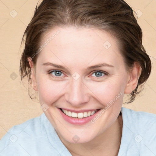 Joyful white young-adult female with medium  brown hair and blue eyes