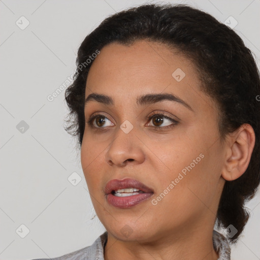 Joyful latino young-adult female with medium  brown hair and brown eyes