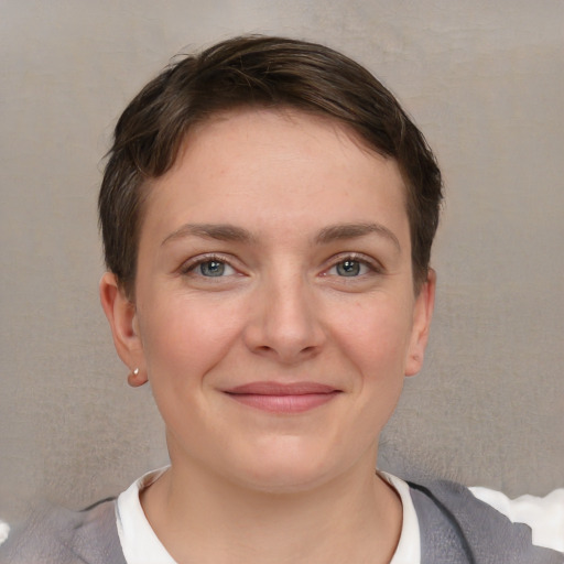 Joyful white young-adult female with short  brown hair and grey eyes