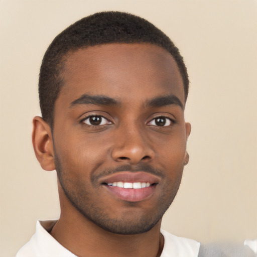 Joyful black young-adult male with short  brown hair and brown eyes