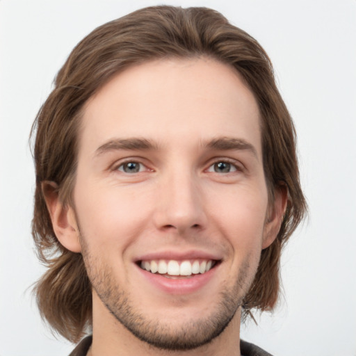 Joyful white young-adult male with medium  brown hair and brown eyes