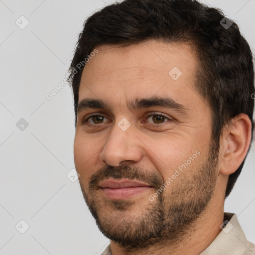 Joyful white adult male with short  brown hair and brown eyes