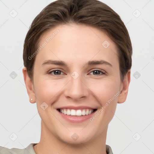 Joyful white young-adult female with short  brown hair and grey eyes