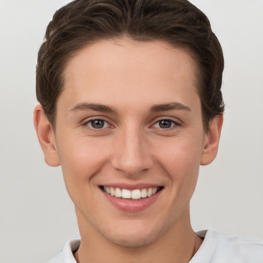 Joyful white young-adult female with short  brown hair and grey eyes