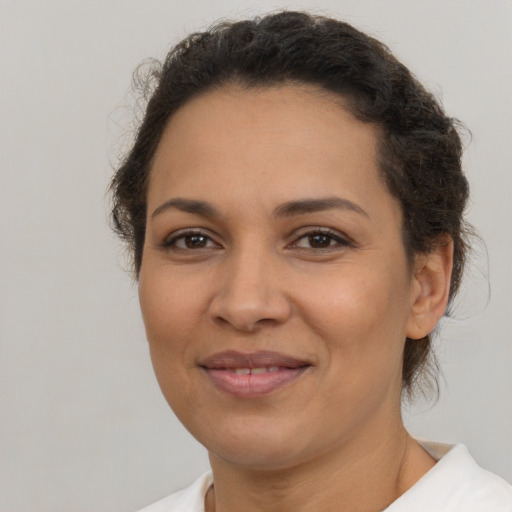 Joyful latino young-adult female with short  brown hair and brown eyes