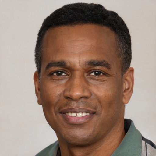 Joyful black adult male with short  black hair and brown eyes